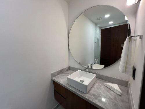 a bathroom with a sink and a mirror at Central Studio with Roof Top Romantic Zone 202 in Puerto Vallarta