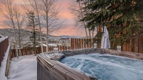 a jacuzzi tub in a snow covered yard at Watchtower Chalet in Steamboat Springs