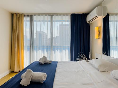 ein Schlafzimmer mit einem großen Bett mit Handtüchern darauf in der Unterkunft Orbi City VIP Apartments In Batumi Center in Batumi