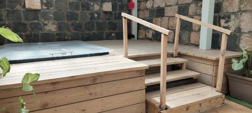 a deck with wooden stairs and a mattress at Love & Lemons in Yesod Hamaala