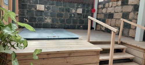 a mattress sitting on a porch next to stairs at Love & Lemons in Yesod Hamaala