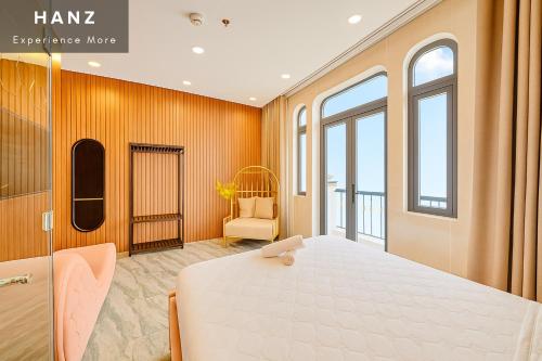 a bedroom with a large bed in a room with windows at S79 Hotel T68 Go Vap in Ho Chi Minh City