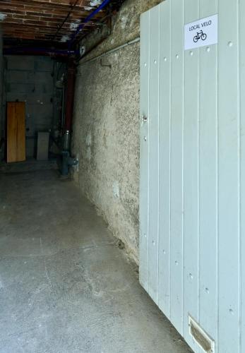 an empty garage with a door with a sign on it at Le Petit Cocon, Hotel Style Ideal for Professionals or Couples in Nevers