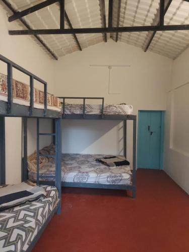 a room with two bunk beds and a door at Haven heights in Kanthalloor