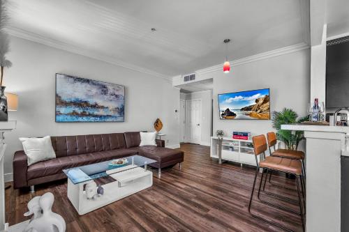 a living room with a couch and a table at Heart of La, Walk to everything!! in Los Angeles