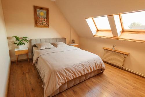 a bedroom with a large bed with a window at Rayon du Soleil in Wintzenheim