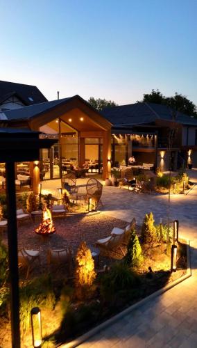 a building with a courtyard with a fire pit at SV Hotel, Restaurant & Airport Parking in Todoreshty