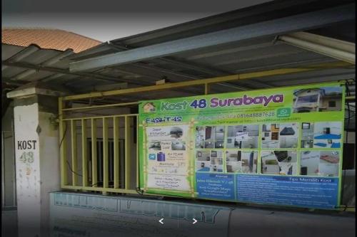 a building with a sign on the side of it at Kost 48 Surabaya in Surabaya