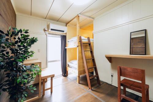 a room with a bunk bed and a desk and chair at 全室個室 Private Stay Guesthouse Opuntia in Ishigaki Island