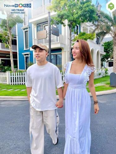 a man and a woman walking down the street at Villa NovaWorld Phan Thiết garden view, 3 BR for 6-8pax in Bình Tú