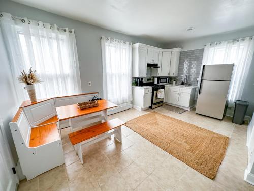a kitchen with a table and a refrigerator at Bohemian Nook At Elm City Flats in New Haven