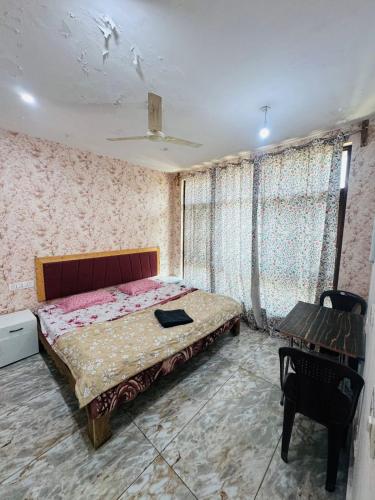 a bedroom with a bed and a table in it at Lakes and peaks in Srinagar