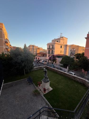 a park with a statue in the middle of a city at Palazzo Sant'Antonio in Rome