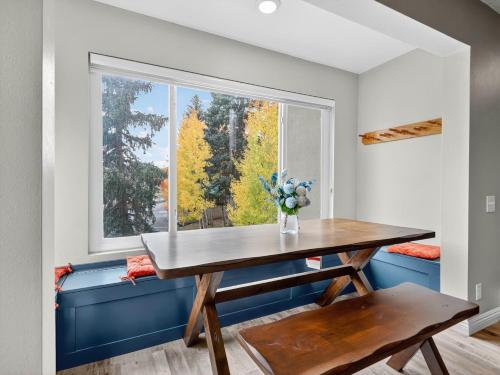 a dining room with a table and a window at Snowy Peaks Haven in Brian Head