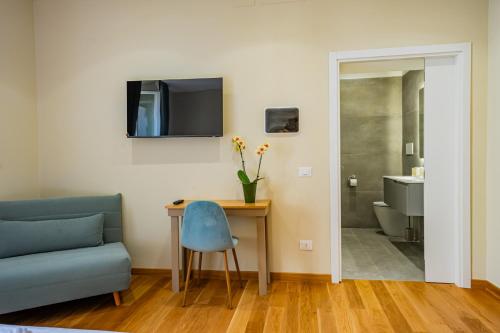 a living room with a couch and a table and a television at MAMA Relais in Rome