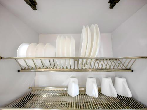 a row of white plates on a shelf in a refrigerator at Edificio Urban in Cajicá