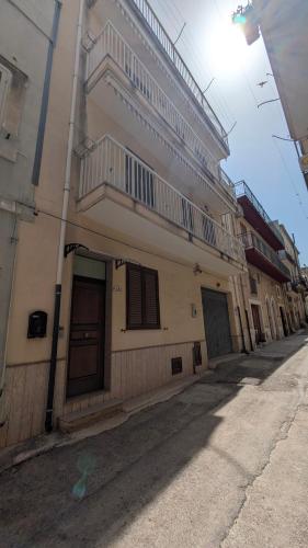 a building with balconies on the side of a street at Casa Migliore - con garage privato in Scicli