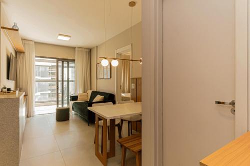 a living room with a table and a dining room at Colibri -ZCotovia Luxo e Aconchego in Sao Paulo