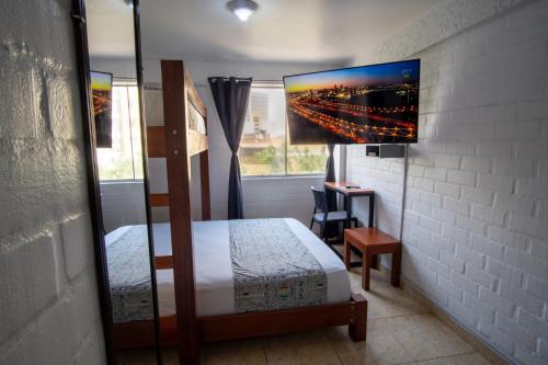 a bedroom with a bed and a desk and a window at Magdalen House in Lima
