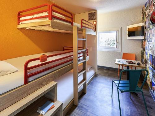 a small room with bunk beds and a desk at hotelF1 Beauvais in Beauvais