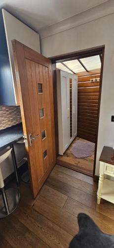 a room with a door and a room with a window at Cosy Studio Quest House in Romford