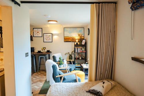 a living room with two chairs and a table at Ashdown Forest Retreat in Nutley