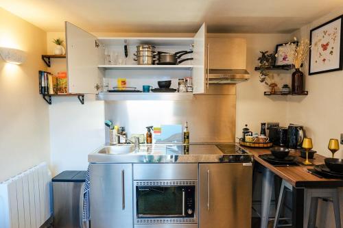a small kitchen with a sink and a counter at Ashdown Forest Retreat in Nutley