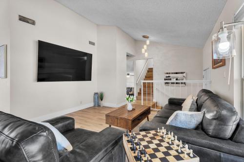 a living room with black leather furniture and a chess board at Strip-side Villa Pool, Mini Golf, Casino games in Las Vegas