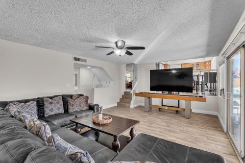 a living room with a couch and a flat screen tv at Strip-side Villa Pool, Mini Golf, Casino games in Las Vegas