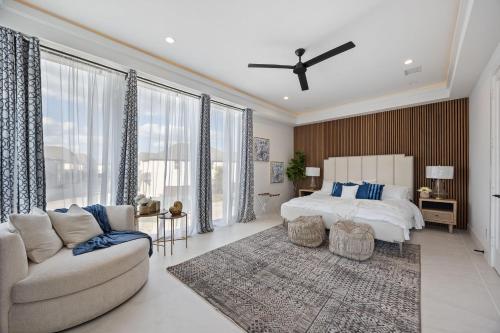 a large bedroom with a bed and a couch at Festive Villa 1 Heart of Richardson TX 6BR 5BA in Richardson