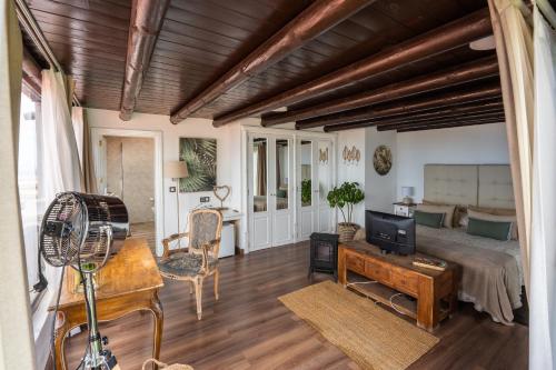 a bedroom with a bed and a desk with a tv at Casona de Tao in Tiagua