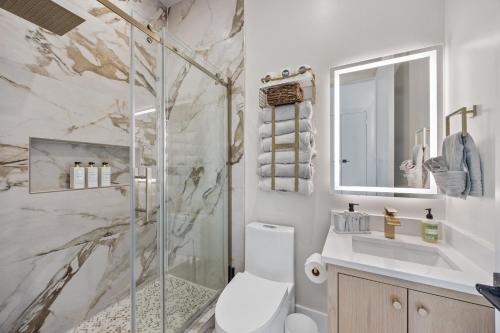 a bathroom with a shower and a toilet and a sink at Festive Villa 1 Heart of Richardson TX 6BR 5BA in Richardson