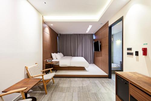 a hotel room with a bed and a desk at Allee Hotel in Yongin
