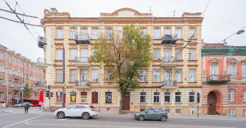 a large building with cars parked in front of it at Sodų 17 Self Check-in - Lollo Stay in Vilnius