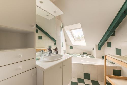 a bathroom with a sink and a tub and a window at Villa Enfance - Piscine privée et proche Lac d'Annecy in Annecy