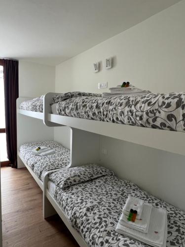 three bunk beds in a room with at Alpine glow - sophisticated ski in - ski out in Breuil-Cervinia