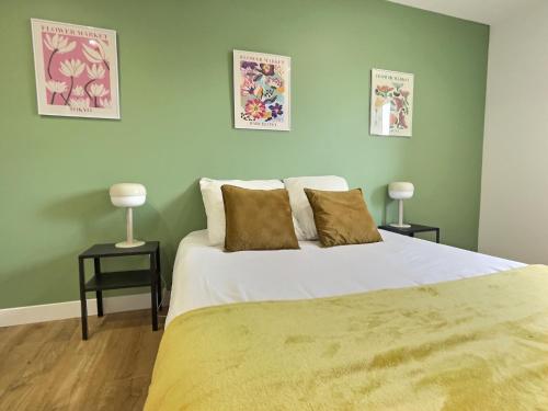 a bedroom with a large bed and two lamps on tables at Pop Centre in Valence