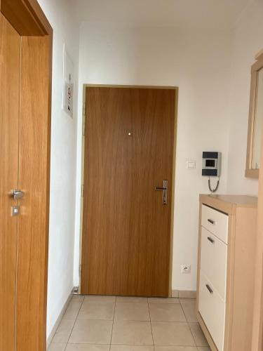 a wooden door in a room with a kitchen at Fine Restaurant & Apartments in Malacky