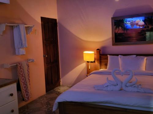 two swans are carved into a bed in a bedroom at Birdies Nest Upper 2 Bedroom Beach View in Black Rock