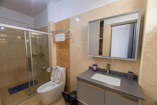a bathroom with a toilet and a sink and a shower at Havena Homes-3 Bedroom Apartment at Kilimani in Nairobi