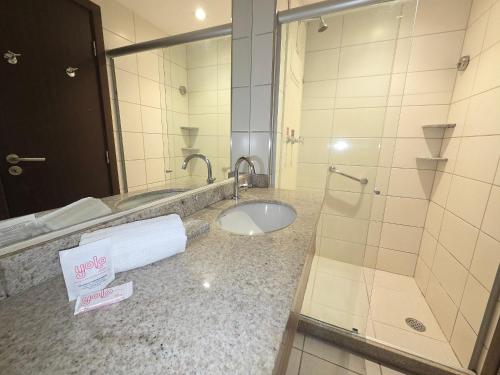a bathroom with a toilet and a sink and a mirror at Beach Class Executive por Yolo in Recife