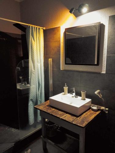 a bathroom with a white sink and a mirror at Quinta Cavaluz in Poceirão