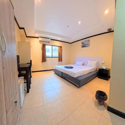 a bedroom with a bed and a desk in it at Stay 94 Patong in Patong Beach