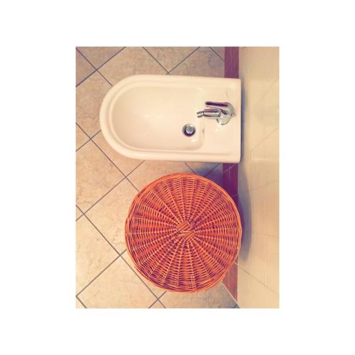 a bathroom with a sink and a red bowl at La Terrazza sul Golfo in Golfo Aranci