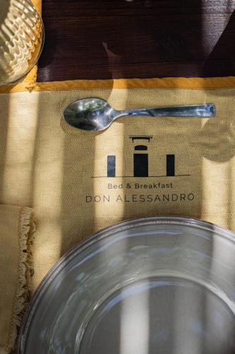 a spoon sitting on top of a napkin next to a plate at B&B Don Alessandro in Surbo