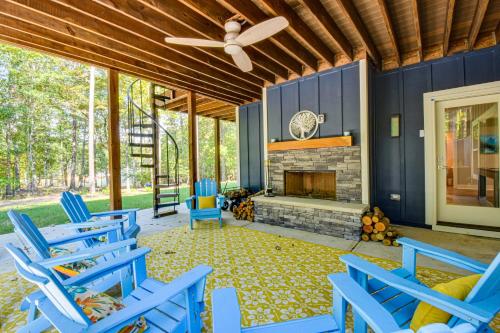 a porch with blue chairs and a fireplace at Waterfront Home on Lake Hartwell with Dock Access in Reed Creek