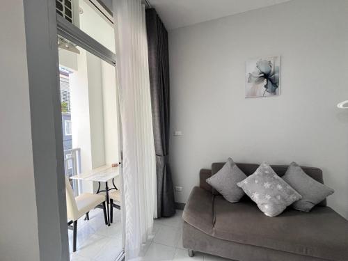 a living room with a couch and a table at Ali House Patong in Patong Beach
