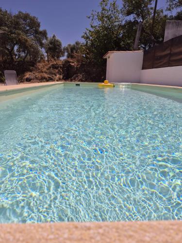 a swimming pool with a yellow object in the water at Luar de Prata in Crato