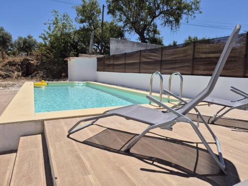 a chair sitting next to a swimming pool at Luar de Prata in Crato
