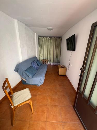 a room with a bed and a chair and a door at Nobleza Nava del Rey in Nava del Rey